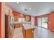 Spacious kitchen featuring stainless steel appliances, tile countertops, and access to the backyard at 3604 Cantura Crest Ct, North Las Vegas, NV 89031