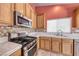 Modern kitchen featuring stainless steel appliances and tiled backsplash at 3604 Cantura Crest Ct, North Las Vegas, NV 89031