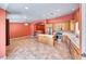 Open-concept living room featuring tile flooring, a fan, kitchen and natural light at 3604 Cantura Crest Ct, North Las Vegas, NV 89031