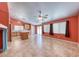 Open-concept living room featuring a fan, tile flooring, kitchen, and natural light at 3604 Cantura Crest Ct, North Las Vegas, NV 89031