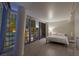 Modern bedroom featuring a king bed, wood-look floors, and a large window showcasing a dazzling city view at 3722 Las Vegas Boulevard S Blvd # 2609, Las Vegas, NV 89158