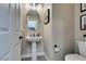 Modern half-bathroom featuring an oval mirror and pedestal sink at 3921 Painted Lady Ave, Las Vegas, NV 89141