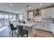 Bright white kitchen featuring an island, stainless steel appliances, and hardwood flooring at 3921 Painted Lady Ave, Las Vegas, NV 89141