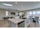 Bright white kitchen featuring an island, stainless steel appliances, and hardwood flooring at 3921 Painted Lady Ave, Las Vegas, NV 89141
