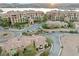 This aerial view of the neighborhood shows multiple units, mature landscaping, and is near the water at 4 Via Centrale # 1, Henderson, NV 89011