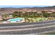 Aerial view of the complex with a pool, putting green, desert landscaping, and lake views at 4 Via Centrale # 1, Henderson, NV 89011
