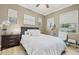 Bedroom with neutral walls, hardwood floors, two windows, and modern furniture with decor at 4 Via Centrale # 1, Henderson, NV 89011