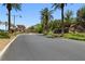 View of the community entrance showcasing lush landscaping, mature trees, and a waterfall feature at 4 Via Centrale # 1, Henderson, NV 89011