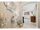 Elegant entryway with travertine flooring, stylish decor, and a view into the living room at 4 Via Centrale # 1, Henderson, NV 89011