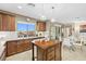 Gourmet kitchen with granite countertops, island, and views of the desert landscape at 4 Via Centrale # 1, Henderson, NV 89011