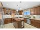 A view of the kitchen with custom cabinets, stainless appliances, and an island at 4 Via Centrale # 1, Henderson, NV 89011
