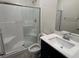 Modern bathroom featuring a tiled shower, toilet, and single sink vanity with contemporary fixtures at 4266 Yucca Brevi Ave, Las Vegas, NV 89139
