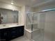 Contemporary bathroom features a double sink vanity and a glass-enclosed shower with modern fixtures at 4266 Yucca Brevi Ave, Las Vegas, NV 89139