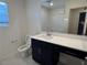 Bathroom with a single sink vanity and toilet visible, complemented by a shower with glass doors in background at 4266 Yucca Brevi Ave, Las Vegas, NV 89139