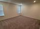 Bright bedroom with neutral carpet, large window, and ample closet space at 4266 Yucca Brevi Ave, Las Vegas, NV 89139