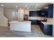 Modern kitchen with black cabinets, stainless steel appliances, and a large center island at 4266 Yucca Brevi Ave, Las Vegas, NV 89139
