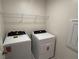 Laundry room with a white, front-loading washer and dryer set at 4266 Yucca Brevi Ave, Las Vegas, NV 89139