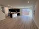 Bright living space with wood-look floors, sliding glass doors to the backyard, and modern kitchen at 4266 Yucca Brevi Ave, Las Vegas, NV 89139