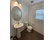 Powder room features a pedestal sink, tile floors, and a window at 5316 Fireside Ranch Ave, Las Vegas, NV 89131