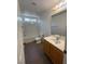 Bathroom features tile floors, single vanity, and a shower/tub combo with built-in shelving at 5316 Fireside Ranch Ave, Las Vegas, NV 89131