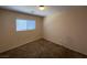 Neutral bedroom featuring carpet, a window with blinds, and a simple light fixture at 5316 Fireside Ranch Ave, Las Vegas, NV 89131