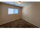 Carpeted bedroom with neutral walls and a window offering plenty of natural light at 5316 Fireside Ranch Ave, Las Vegas, NV 89131