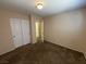 Bedroom with neutral walls, carpet, double door closet, and an open doorway to the hallway at 5316 Fireside Ranch Ave, Las Vegas, NV 89131