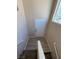 Stairway to a well-lit entryway with a white door and light hardwood flooring at 5316 Fireside Ranch Ave, Las Vegas, NV 89131