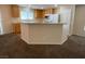 Well-lit kitchen features wood cabinets, neutral countertops, and a breakfast bar area at 5316 Fireside Ranch Ave, Las Vegas, NV 89131