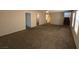 Spacious living room with plush carpet, ceiling fan, and multiple windows for natural light at 5316 Fireside Ranch Ave, Las Vegas, NV 89131