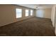 Large living room featuring neutral walls, carpet, a ceiling fan, and large windows for lots of light at 5316 Fireside Ranch Ave, Las Vegas, NV 89131