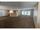 Open-concept living room with a view into the kitchen and bright natural light at 5316 Fireside Ranch Ave, Las Vegas, NV 89131