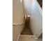 Carpeted staircase leading to the next level, featuring a handrail and neutral walls at 5316 Fireside Ranch Ave, Las Vegas, NV 89131