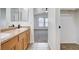 Bathroom vanity with double sinks, tile floors, and access to a bedroom with natural light at 5521 Jackpot Winner Ln # 101, Las Vegas, NV 89122