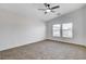 Spacious bedroom with vaulted ceiling, carpet, ceiling fan, and two bright windows at 5521 Jackpot Winner Ln # 101, Las Vegas, NV 89122