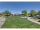 Community park with playground, picnic benches, trees, and manicured green lawns at 5521 Jackpot Winner Ln # 101, Las Vegas, NV 89122