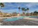 Community pool deck with swaying palm trees, lush landscaping and comfortable seating at 5521 Jackpot Winner Ln # 101, Las Vegas, NV 89122