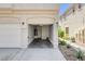 Two car garage with an open door, concrete flooring, and access to water heater at 5521 Jackpot Winner Ln # 101, Las Vegas, NV 89122