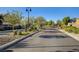 View of the gated entrance with mature landscaping enhancing curb appeal within a secure residential community at 5521 Jackpot Winner Ln # 101, Las Vegas, NV 89122