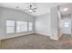 Large living room featuring neutral walls, carpet, and a ceiling fan at 5521 Jackpot Winner Ln # 101, Las Vegas, NV 89122