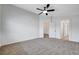 Spacious bedroom with plush carpeting, a ceiling fan, and ensuite bathroom access at 5521 Jackpot Winner Ln # 101, Las Vegas, NV 89122