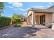 Inviting backyard featuring a covered patio, gravel landscaping, lawn and guest house at 5601 Mackenzie Park Ct, Las Vegas, NV 89130