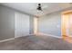 Spacious bedroom with neutral walls, carpet flooring, and a ceiling fan at 5601 Mackenzie Park Ct, Las Vegas, NV 89130
