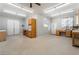 Spacious garage with ample lighting, built-in cabinets, storage, and workbench areas at 5601 Mackenzie Park Ct, Las Vegas, NV 89130