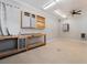 This garage features overhead lighting, a ceiling fan, shelving, storage and ample counter space at 5601 Mackenzie Park Ct, Las Vegas, NV 89130