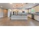 Spacious kitchen features stainless appliances, ample cabinetry and large island with seating at 5601 Mackenzie Park Ct, Las Vegas, NV 89130