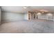 Large and open living room with plush carpeting, neutral tones, and plenty of natural light at 5601 Mackenzie Park Ct, Las Vegas, NV 89130