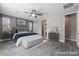 A staged main bedroom featuring neutral paint, ceiling fan and coordinated furnishings at 5601 Mackenzie Park Ct, Las Vegas, NV 89130