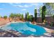 Beautiful pool featuring a waterfall, lush landscaping, and plenty of room to relax and entertain at 5601 Mackenzie Park Ct, Las Vegas, NV 89130