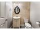 Well-lit half bathroom featuring stylish accents and a decorative mirror at 5601 Mackenzie Park Ct, Las Vegas, NV 89130